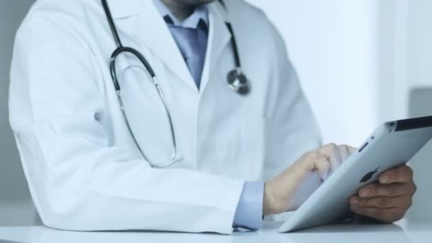 Doctor Using Digital Tablet at Work - Video, Çekim
