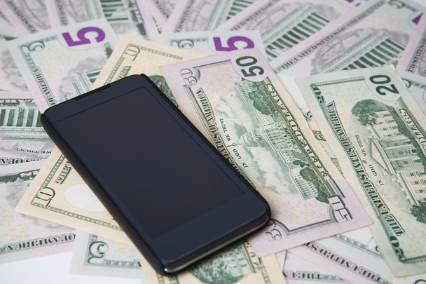 Phone on a background of money - Zdjęcie, obraz