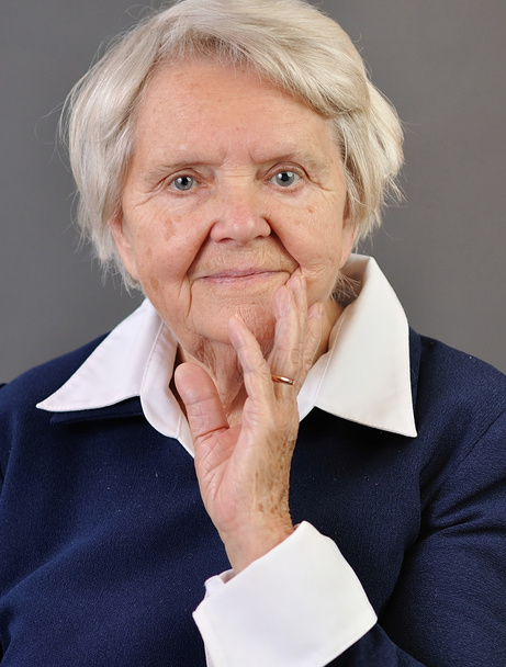 Senior happy woman with grey hairs against grey background.  - Fotografie, Obrázek
