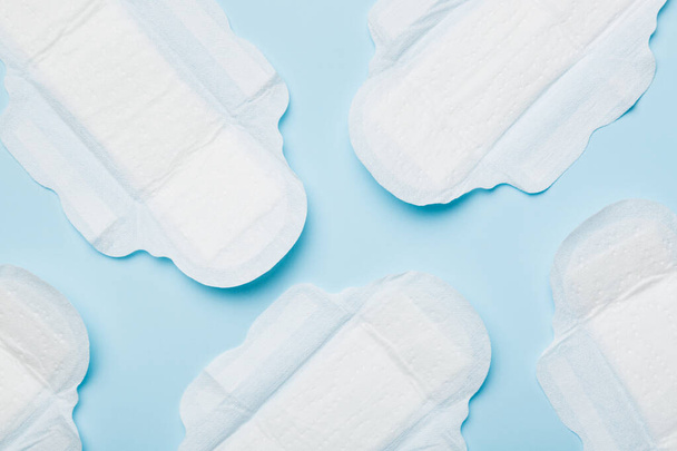 Women hygiene products or sanitary pad on colored background. Pastel color. Closeup. Empty place for text. Female daily hygiene. - Photo, Image