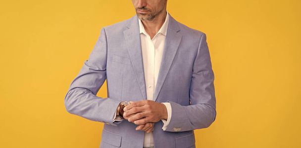 cropped man check time on watch in formalwear on yellow background, tempo. - Foto, Imagem