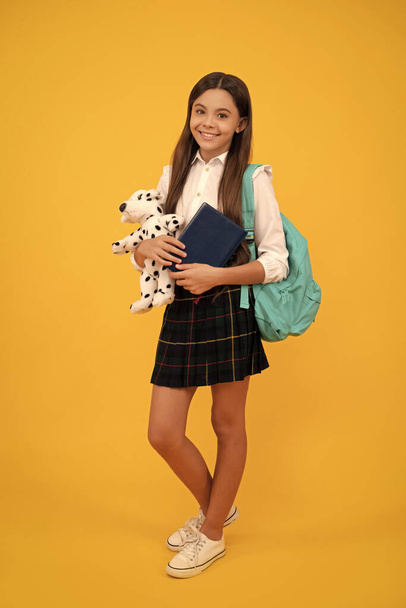 teen girl ready to study. happy childhood. cheerful kid going to do homework. teenager student hold planner notebook. education in high school. schoolgirl with notepad and toy. back to school. - Foto, Imagem
