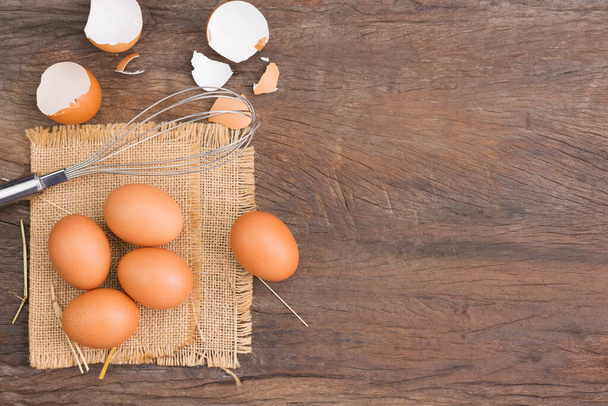 Farm fresh organic eggs laid on a rustic wooden table, top view. - Foto, imagen