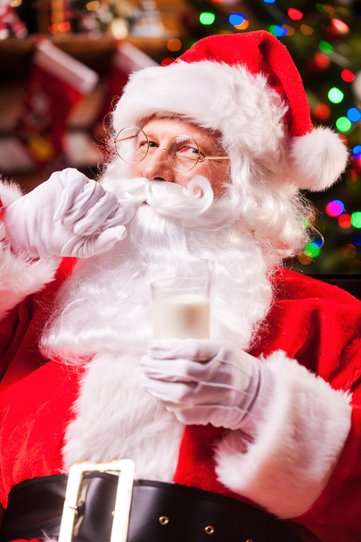 Santa Claus holding glass with milk - Photo, Image