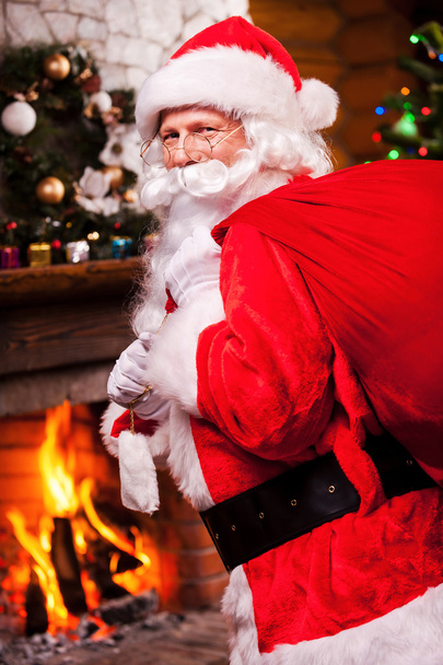 Santa Claus carrying sack with presents - Photo, Image