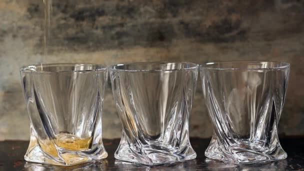 Pouring whiskey in three glasses - Felvétel, videó