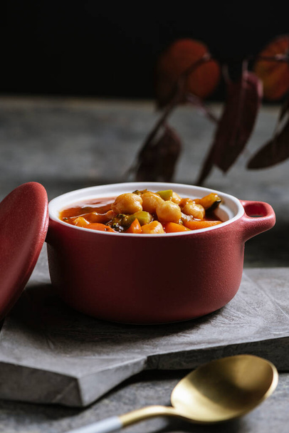 Vegan food, chickpeas stewed with tomatoes, zucchini carrots and peppers on bowl - 写真・画像
