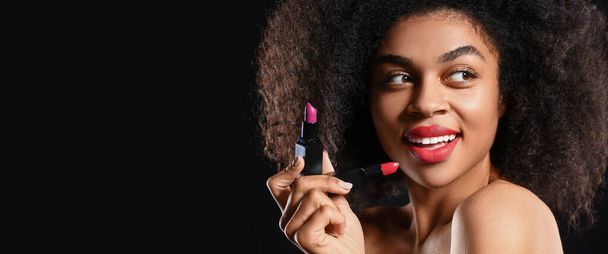 Portrait of beautiful African-American woman with bright lipstick on dark background with space for text - Fotografie, Obrázek