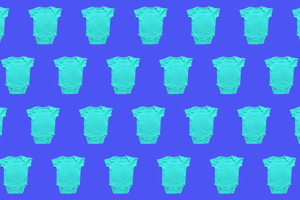 Many baby bodysuits on blue background. Pattern for design - Photo, Image