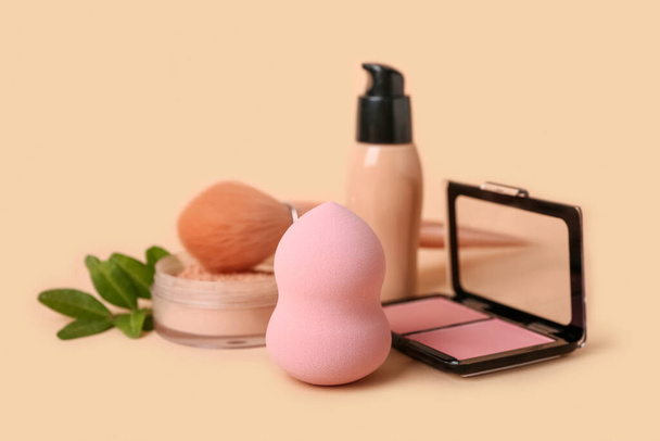 Makeup sponge and cosmetics on color background - Photo, Image