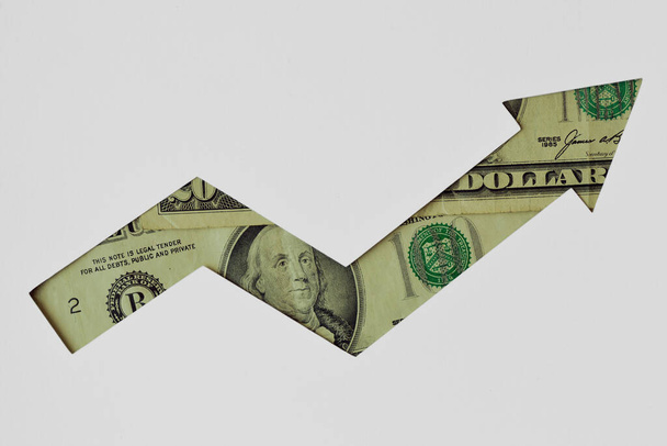 Upward arrow made of dollar banknotes on white background - Concept of upward trend of dollar currency - Photo, Image