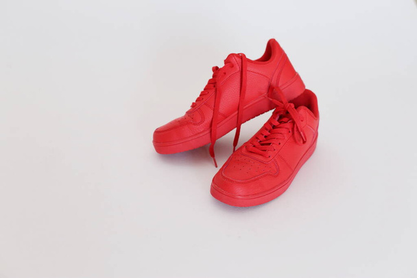 Red sports sneakers on the table - Фото, изображение