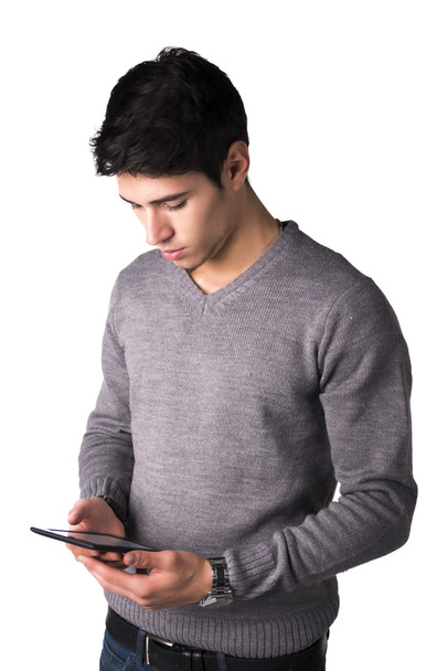 Handsome young man holding ebook reader - Foto, afbeelding
