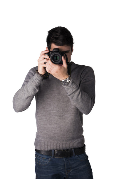 Handsome young man taking photo with professional photocamera - Zdjęcie, obraz