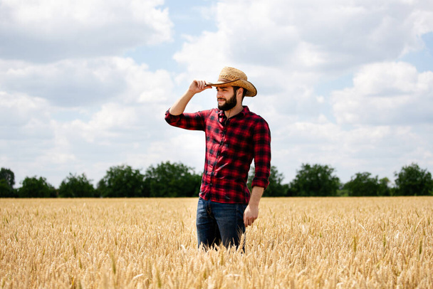 Portrait of farmer standing in wheat field. - Photo, Image