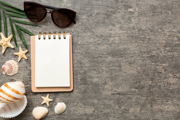 Blank writing book with summer beach accessories on background, copy space. Flat lay with copy space. - Foto, imagen