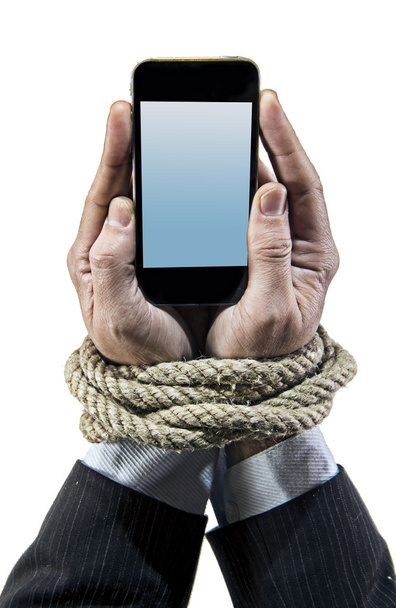Hands of businessman addicted to mobile phone rope bond wrists in smartphone internet addiction - Photo, Image