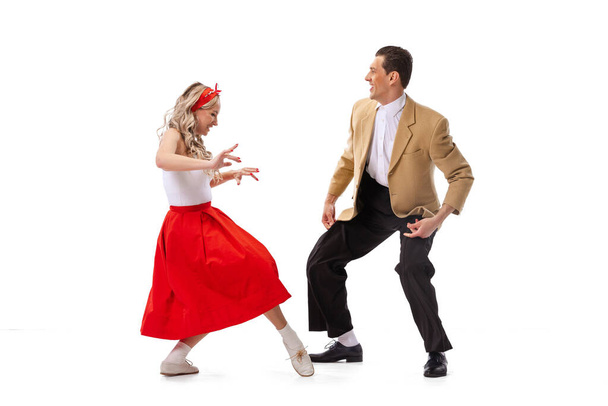 Expressive couple of dancers in vintage retro style outfits dancing social dance isolated on white background. Timeless traditions, 60s ,70s american fashion style. Dancers look excited - Fotoğraf, Görsel