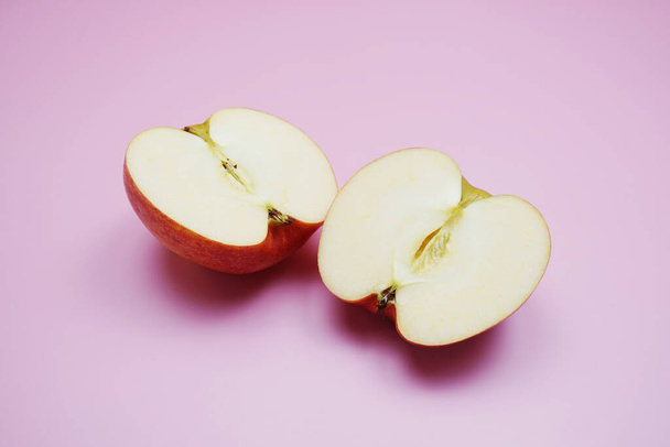 Apple cut half slices on pink background - Fotoğraf, Görsel