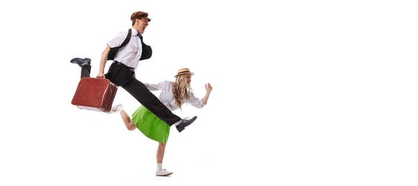 Dynamic portrait of dancing couple in vintage style clothes dancing, jumping isolated on white background. Concept of art, music, 60s ,70s american fashion style. Emotions, expressions. Flyer - Фото, изображение