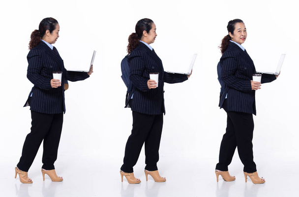 Full length 40s 50s Asian Senior Woman business executive manager, walking forward left right, wear black suit pants. Smile office female stands feels smile happy over white background isolated - Photo, Image