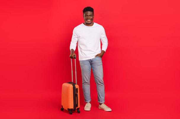 Full size photo of confident attractive male leaving for summer holidays waiting for departure isolated on red color background. - Fotoğraf, Görsel