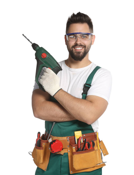 Young worker in uniform with power drill on white background - Foto, Bild