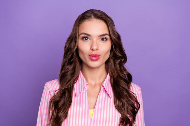 Photo portrait woman wearing striped shirt sending air kiss on date isolated pastel violet color background. - Фото, изображение