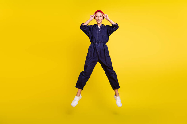 Full length body size view of attractive cheerful girl jumping having fun rest isolated over bright yellow color background. - Valokuva, kuva