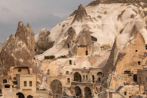 typical houses on the rocks in the city of Cappadocia, Turkey, on a cloudy day, in winter. - Photo, Image