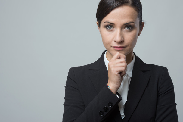 Business woman with hand on chin - Photo, image