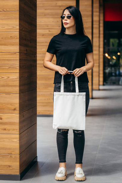 Giovane asiatico modello ragazza su il strada holding bianco eco bag, mock up - Foto, immagini