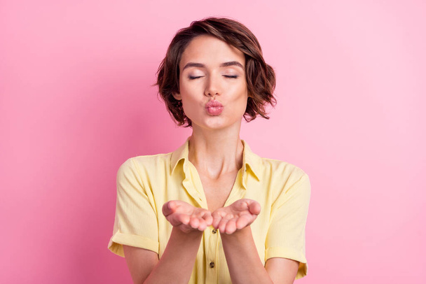 Photo of young woman pouted lips send air kiss you flirty romance isolated over pink color background. - Foto, Imagem