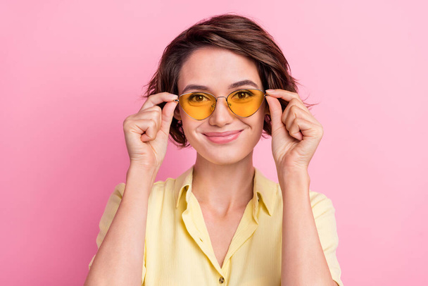 Photo of nice millennial brunette lady wear yellow t-shirt eyewear isolated on pink color background. - Foto, afbeelding