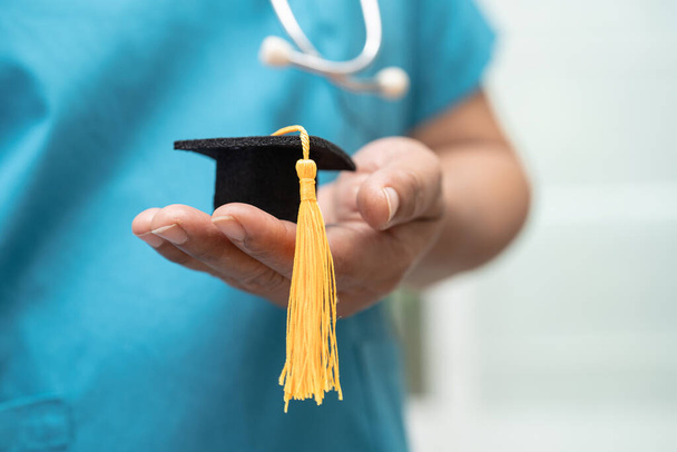 Asian doctor study learn with graduation gap hat in hospital ward, clever bright genius education medicine concept. - Фото, изображение