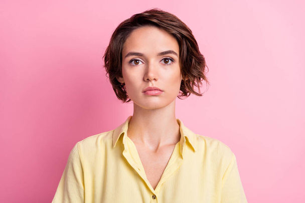 Photo of calm millennial brunette lady wear yellow shirt isolated on pink color background. - Foto, imagen