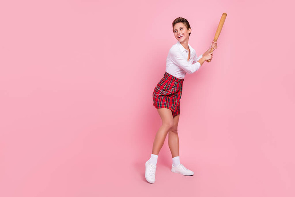 Full length photo of happy positive cheerful woman look empty space play baseball isolated on pink color background. - Foto, immagini
