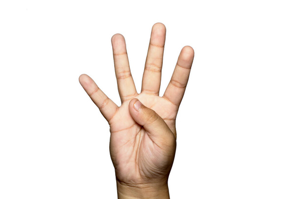 A closeup of a boy raising four fingers up on white background - Foto, afbeelding
