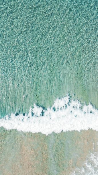 A vertical aerial shot of sea waves - 写真・画像