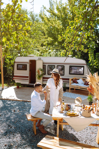 Newlyweds tenderly hug, kiss and enjoy each other  in rv, camping in a trailer.  Wedding. Love. Romantic moment. - Foto, immagini
