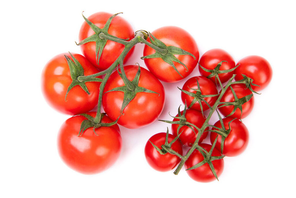 Organic red cherry tomato clusters of different size isolated on white. - 写真・画像