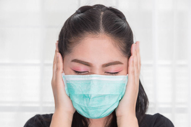 Asian woman wears a medical mask to protect against Covid's disease. - Photo, image