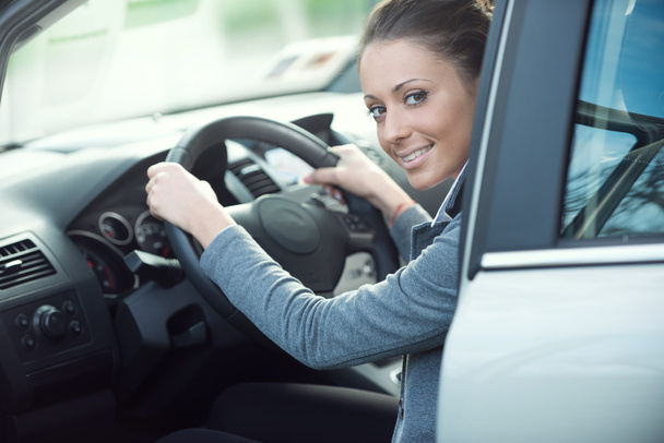 Smiling woman driving a car - Фото, зображення