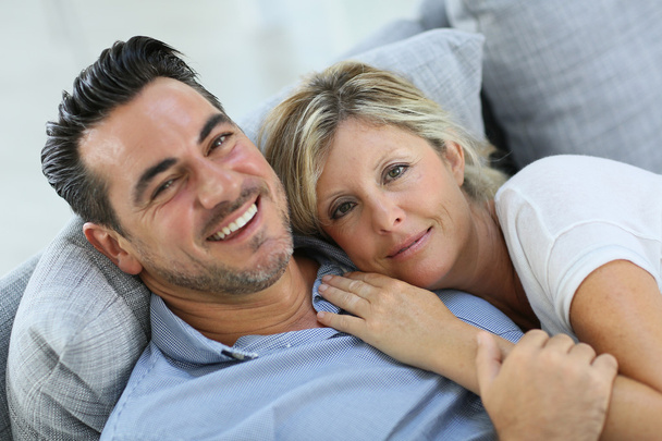Mature couple relaxing in sofa - 写真・画像