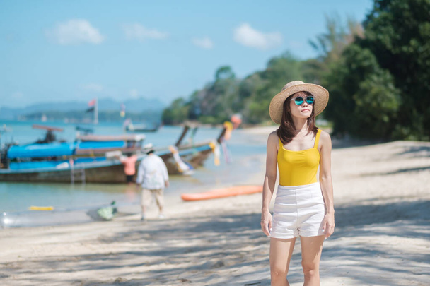 Жінка - туристка в жовтому купальнику і капелюсі, щаслива мандрівниця на пляжі Раю на островах. Місце призначення, мандрівка по Азії, тропічне літо, відпустка та свята концепція - Фото, зображення