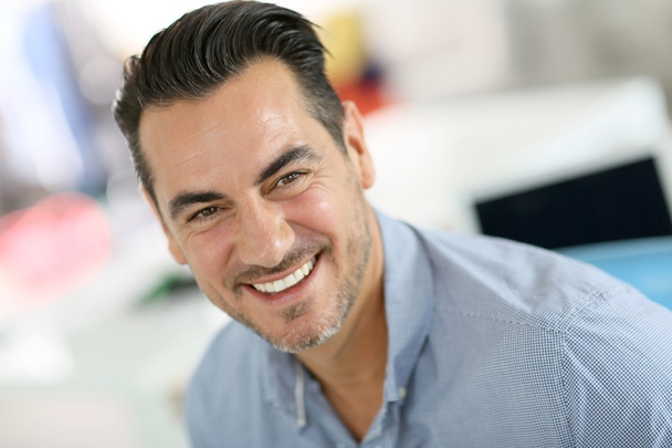 Cheerful businessman in office - Photo, Image