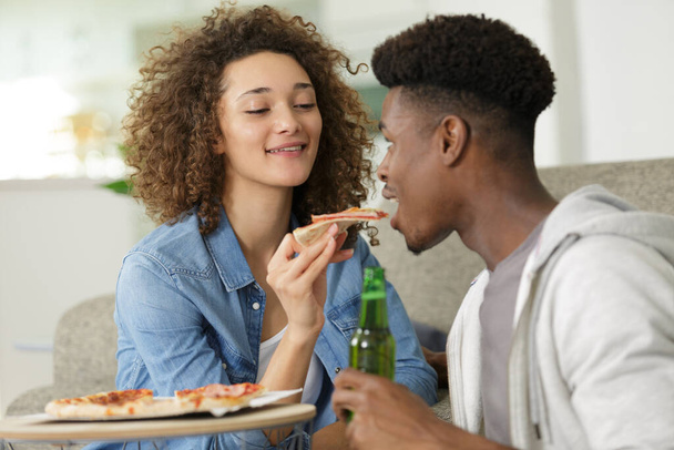 couple eating pizza snack outdoors - Foto, immagini
