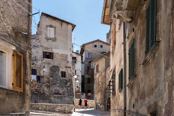Scanno, Italy-august 8, 2021:people strolling through the narrow streets of Scanno, one of the many ancient villages of Italy during a summer day - Photo, Image