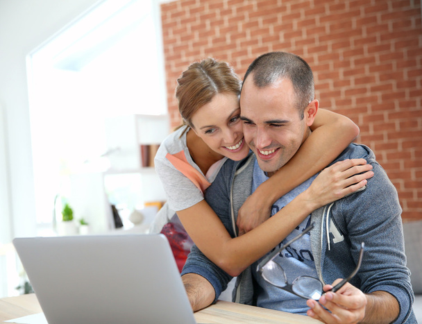 Couple websurfing on internet with laptop - Photo, Image