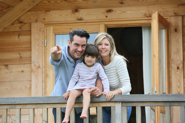 Family enjoying vacation in log cabin - Foto, Imagen